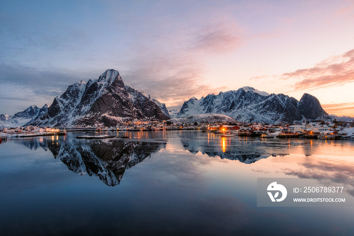 Fishing village with snow mountain at sunrise