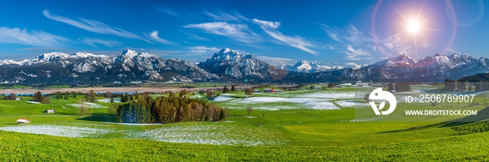 beautiful rural landscape in Bavaria with mountain range and meadow at springtime