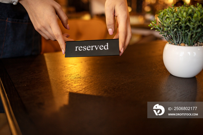 Elegant Restaurant Table Setting Service for Reception with Reserved Card. Restaurant waiter placing