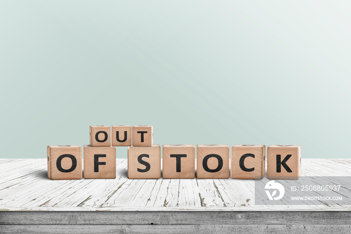 Out of stock sign standing on a wooden table