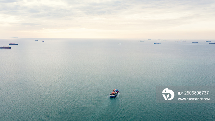 aerial seascape view and small container ship floating in sea horizon and cloud sky background