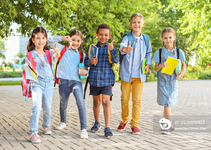 Group of cute little pupils outdoors