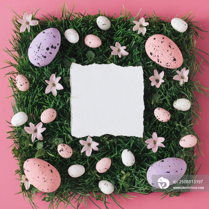 Creative flat lay composition with easter eggs and natural grass and flowers.Pastel colors and soft 