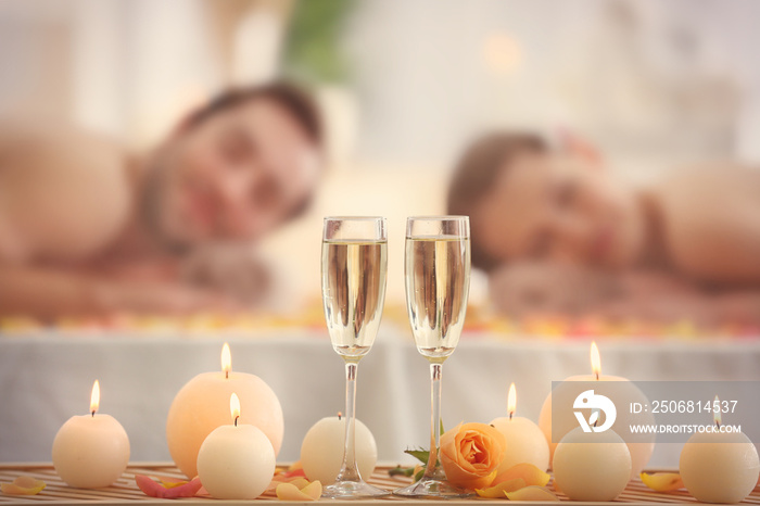 Beautiful spa composition with glasses and happy couple on background