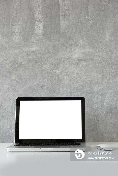 Mockup laptop computer with empty display on white table with loft wall.