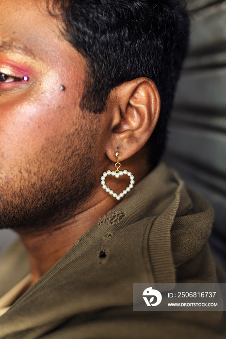 portrait of dark skinned Indian man in Malaysia, with theatrical facial expressions, in the alleyway