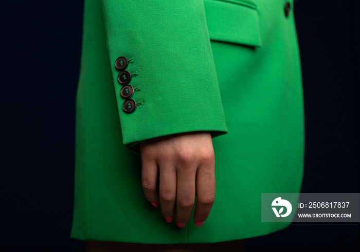 Close up image of fashionable green blazers on a woman. Womans fashion classic jacket in details. M