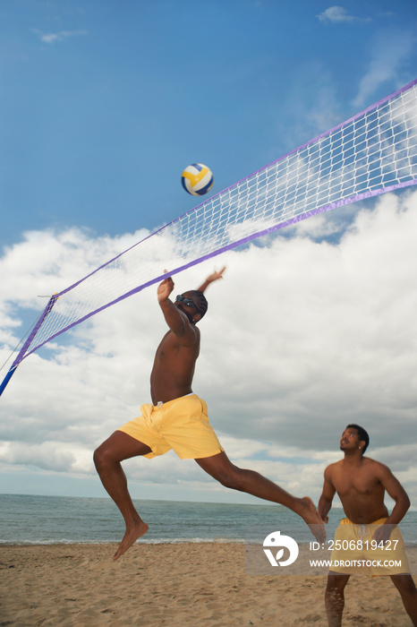 Friends playing volleyball on beach