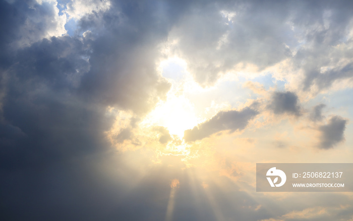 Beautiful sunlight through a clouds on sky background at the evening. Natural tone.