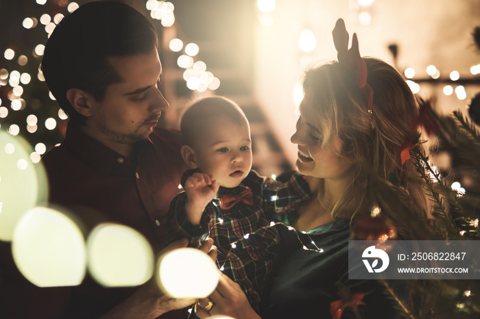 Happy mother and her cute little son are celebrating Christmas or New year.