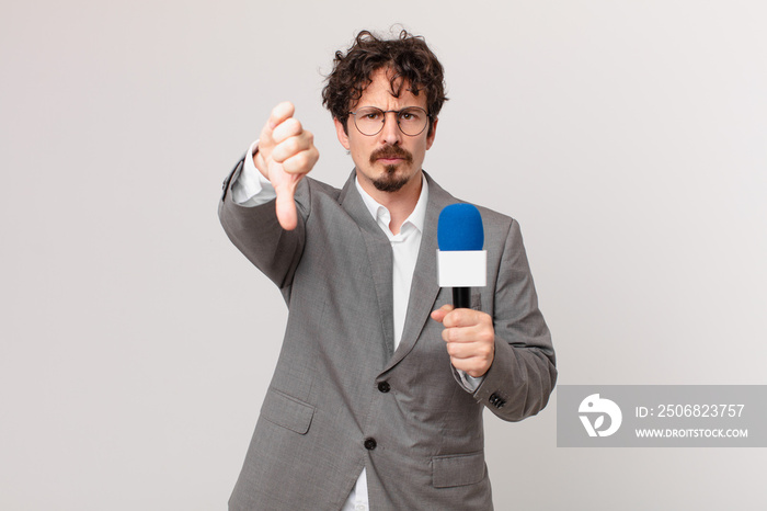 young man journalist feeling cross,showing thumbs down