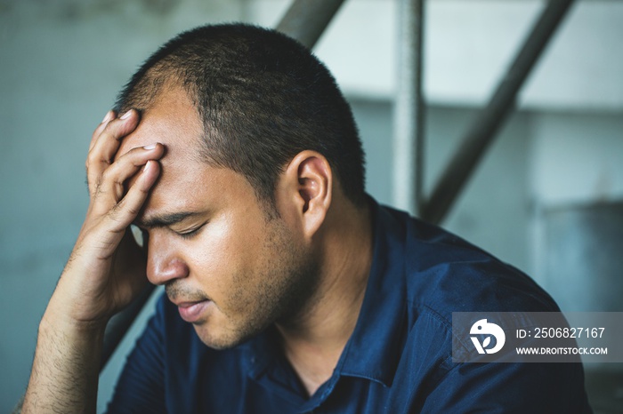 depressed man sitting in dark room