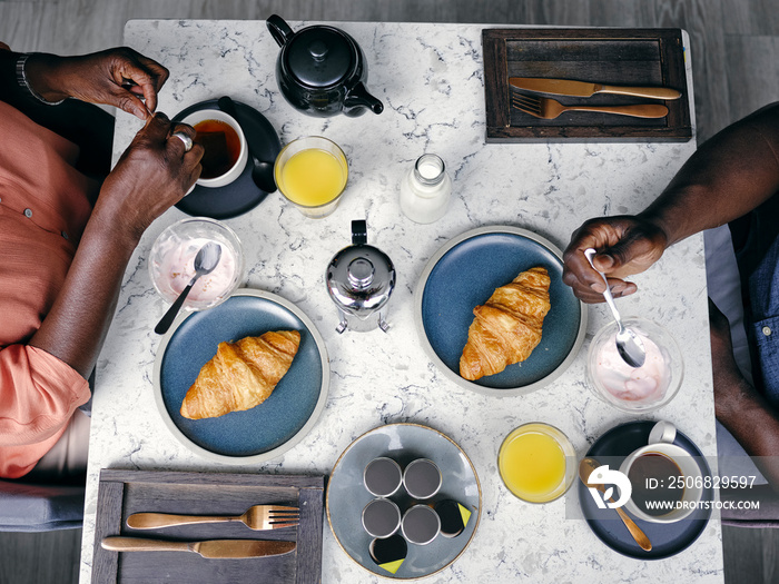 UK, Overhead view of couple having breakfastÊat hotel table