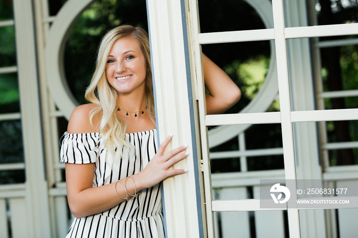 High School Senior Photo of Blonde Caucasian Girl Outdoors in Romper Dress