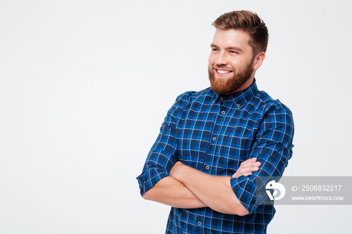 Young bearded man with folded hands smiling to camera