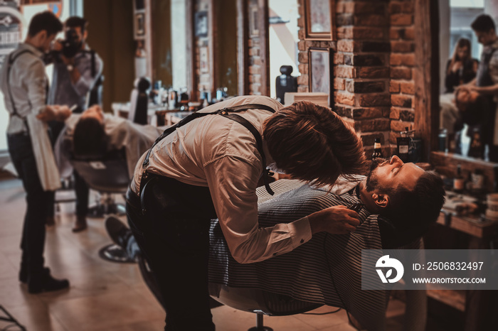 Attractive brutal man just got good beardcare from talanted trendy barber.