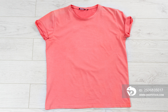 pink t shirt mock up on wooden background top view, red T-shirt background