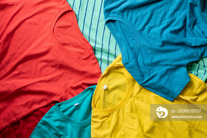 Pile of mixed dirty colorful clothes ready for washing on the black background , house cleaning and 