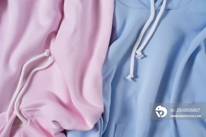 Close up shot of two pale blue and pink pastel blank cotton hoodie. Template
