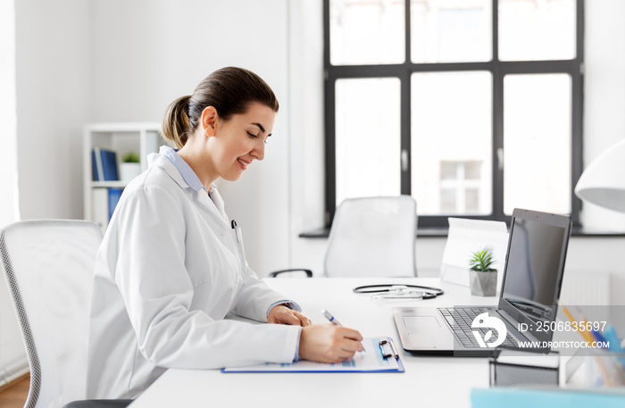 medicine, healthcare and profession concept - smiling female doctor in white coat with laptop comput