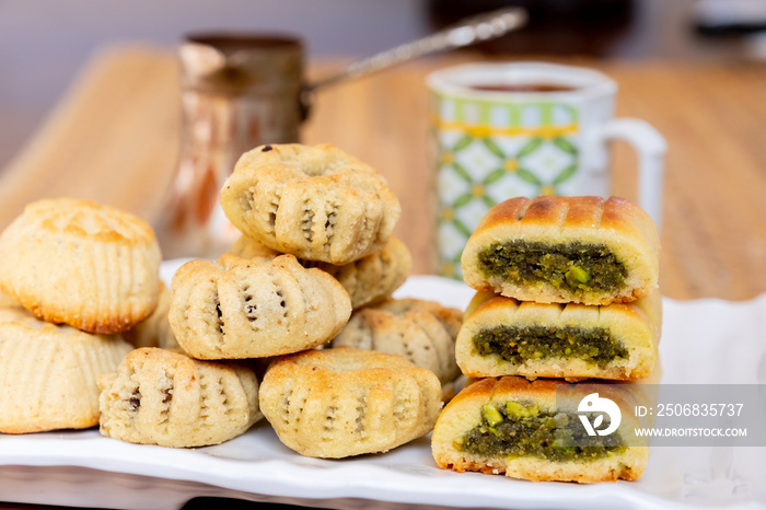 Arabic sweets, maamoul and coffee on traditional background