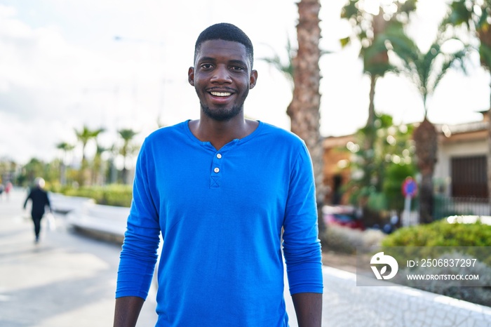 Young african american man smiling confident standing at street