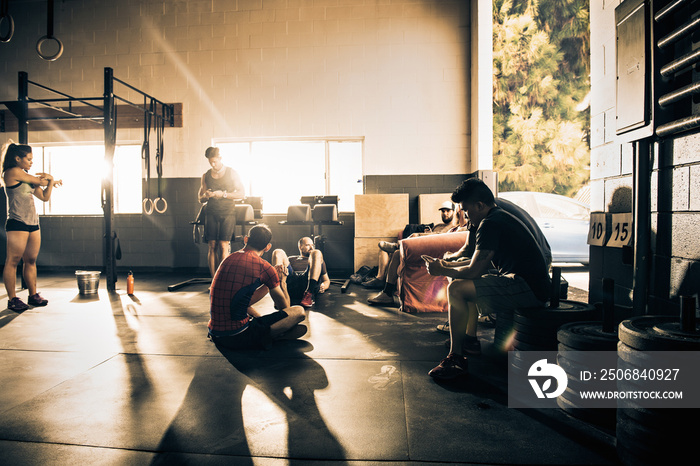 Group of people taking a break from training in gymnasium