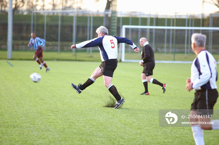 Football player kicking ball