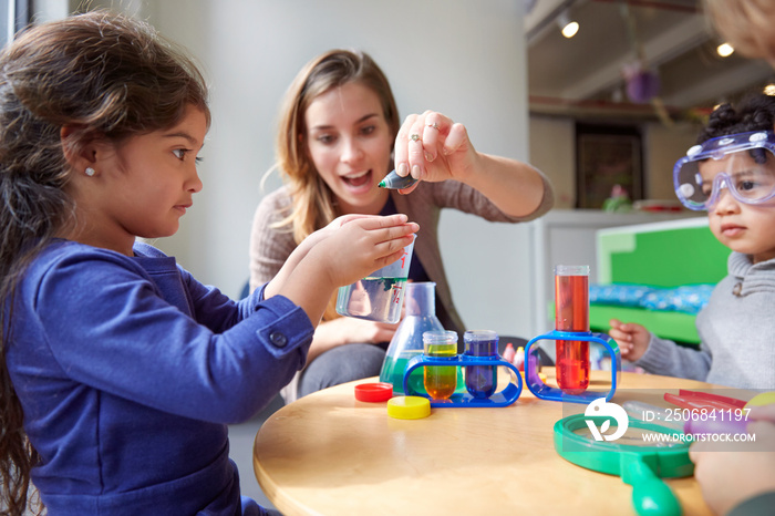 Children (2-3, 4-5) playing with toys