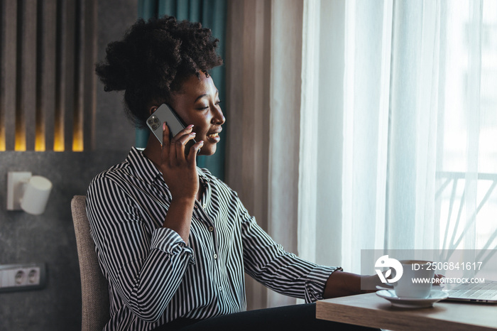 Outraged attractive employee talking on the phone, arguing with a client or customer, actively gestu