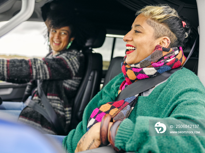 Smiling women traveling by car