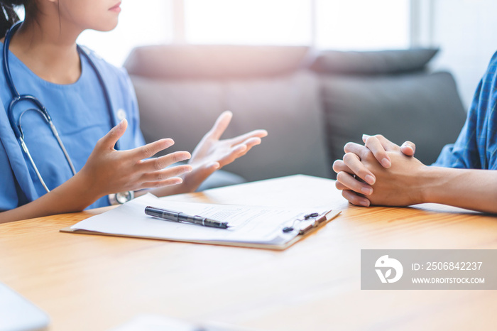 Close up asian female doctor writing and filling forms and hand gesture of explaining on patients he