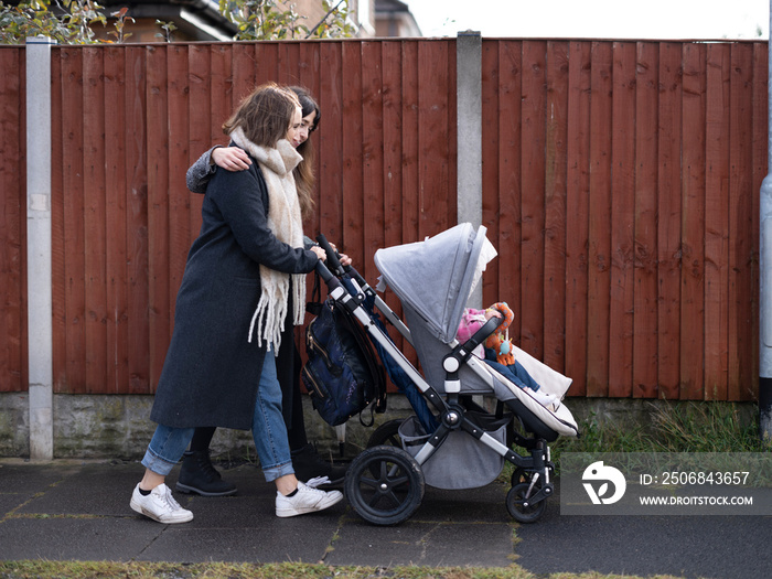 Women walking with stroller�