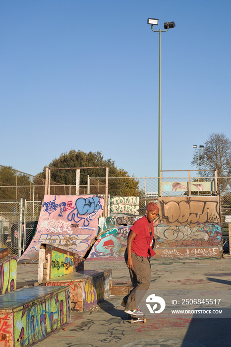 Portrait of young non-binary riding skateboard