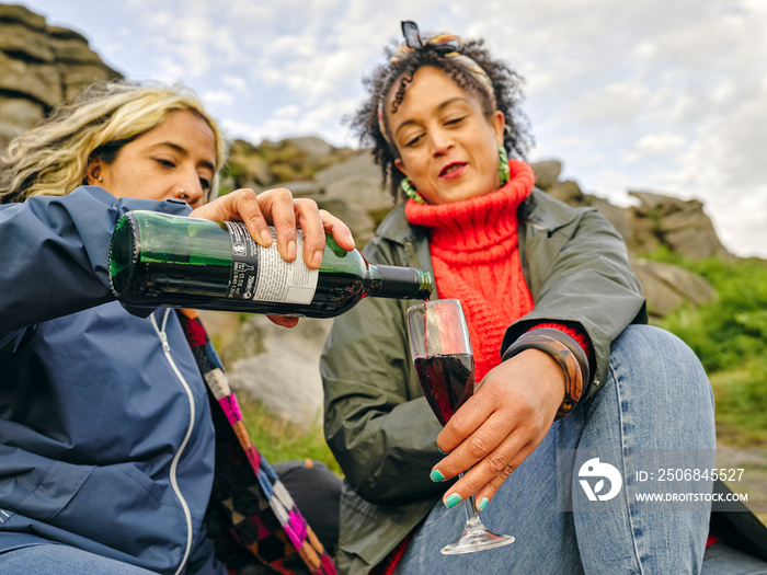 Female hikers drinking wine