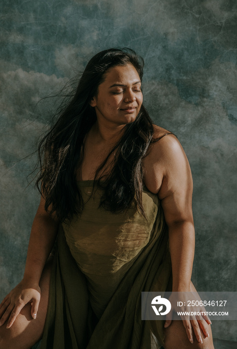 Portrait of an East Indian woman sitting with face to the sun