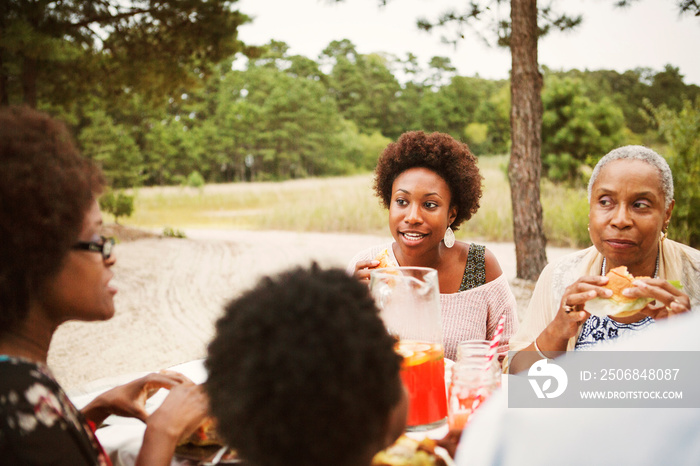 Three women eating meal outdoors