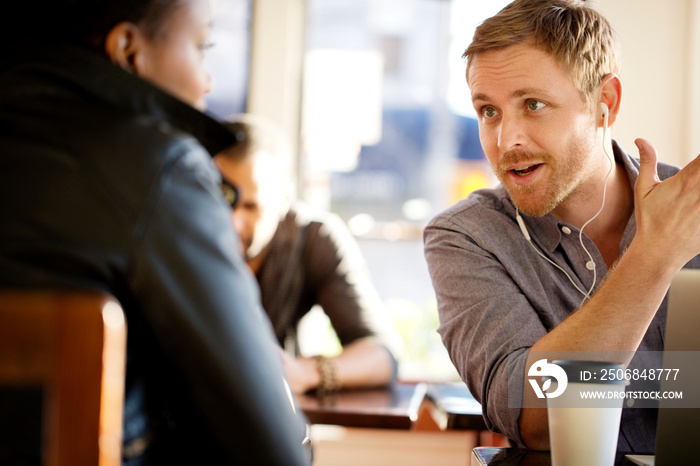 Man talking with woman in cafe