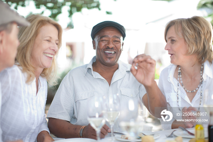 Older friends having wine together