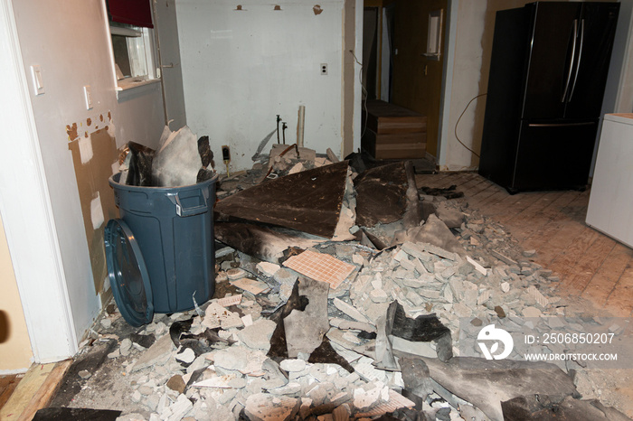 Kitchen demolition with a pile of tiles and trash