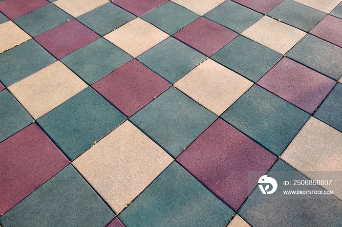 Close up of soft rubber tiles for covering at outdoor gym of stadium at preschool yard.