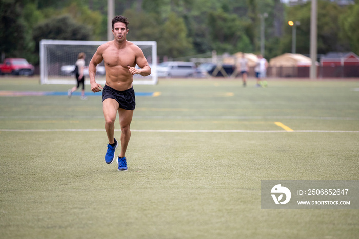 Man running on a soccer field