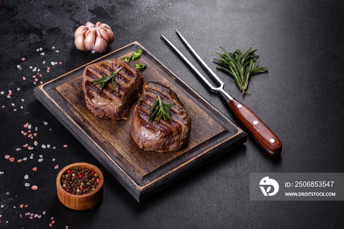 Fresh juicy delicious beef steak on a dark background