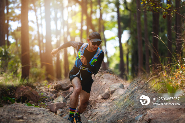 一名男子越野跑运动员和穿着运动鞋在森林中越野跑的运动员