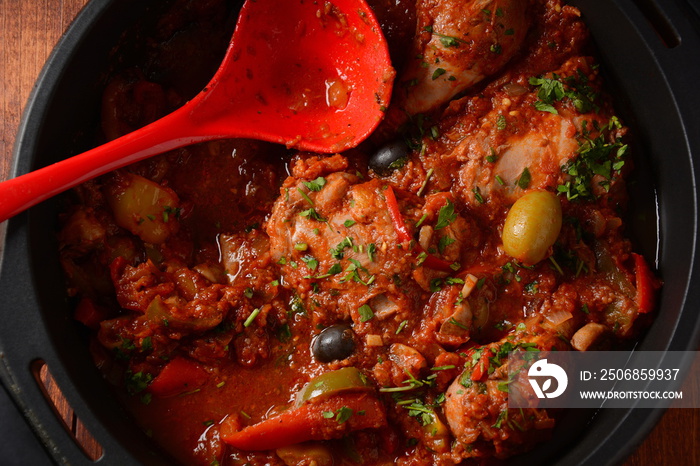 Chicken cacciatore with bell peppers, tomatoes, black olives. Italian food