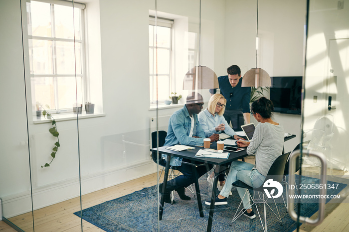 Diverse young businesspeople discussing work together in an offi