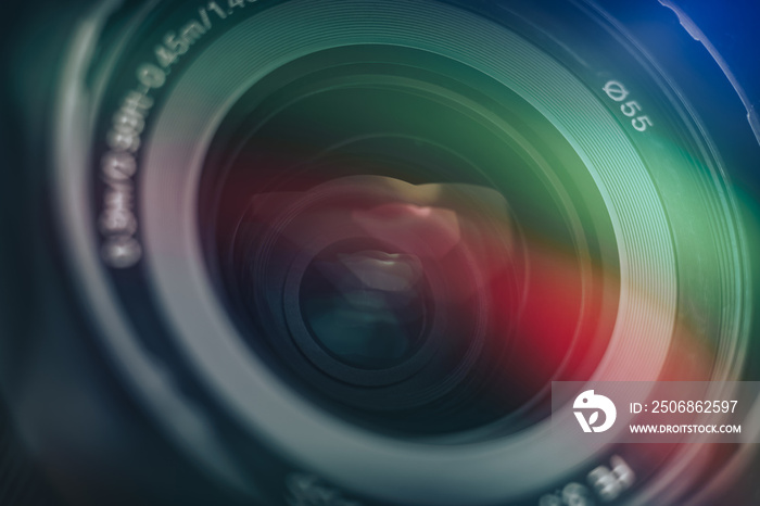 Close up Beautiful camera lens with multi colored light. Background pattern for design..