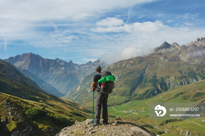 A hiking trip with a backpack of alpine mountains.