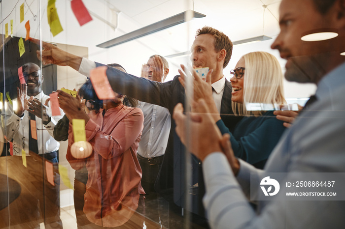 Smiling businesspeople clapping after a brainstorming session in