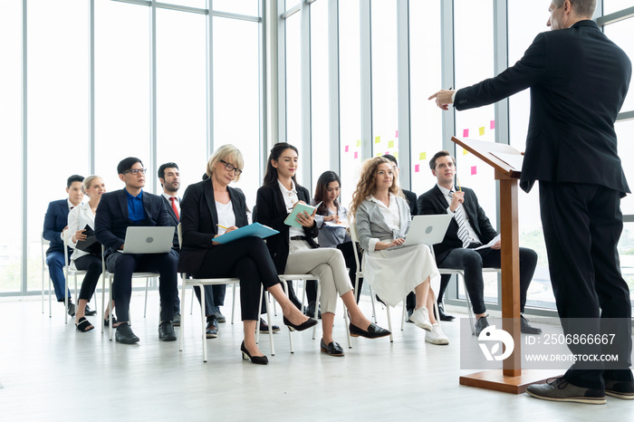 Group of business people meeting in a seminar conference . Audience listening to instructor in emplo